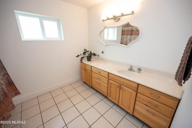 bathroom featuring tile patterned floors, baseboards, and vanity
