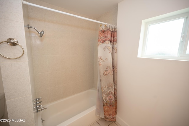 bathroom featuring tile patterned floors, shower / tub combo with curtain, and baseboards
