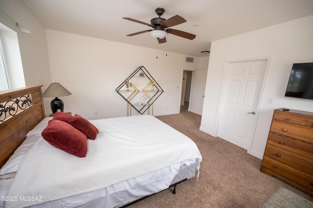 bedroom featuring baseboards, a ceiling fan, visible vents, and carpet