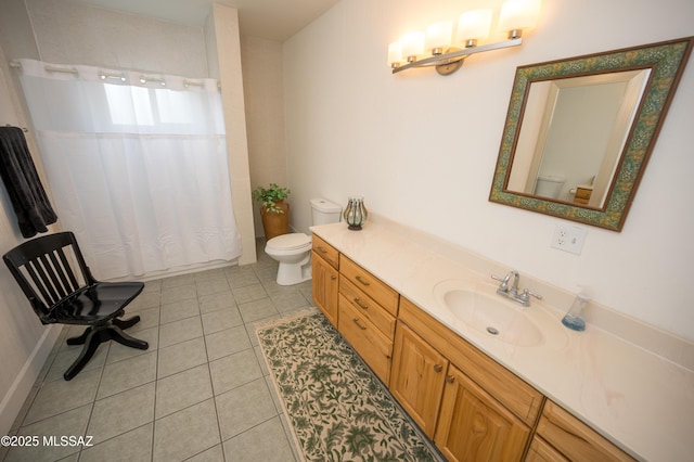 bathroom with toilet, vanity, curtained shower, and tile patterned floors