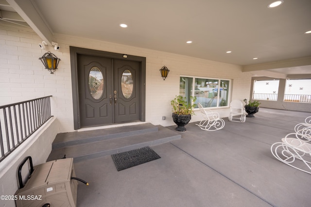 doorway to property featuring brick siding