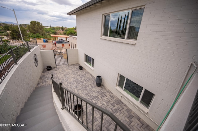 view of patio with a gate and fence