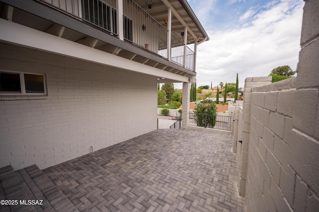 view of patio with a gate and fence