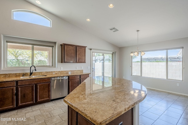kitchen with lofted ceiling, stainless steel dishwasher, light tile patterned floors, a sink, and a center island