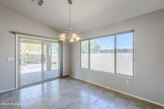 empty room featuring an inviting chandelier, vaulted ceiling, visible vents, and baseboards