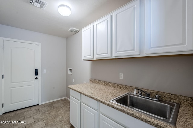 laundry area featuring hookup for a washing machine, a sink, cabinet space, baseboards, and visible vents