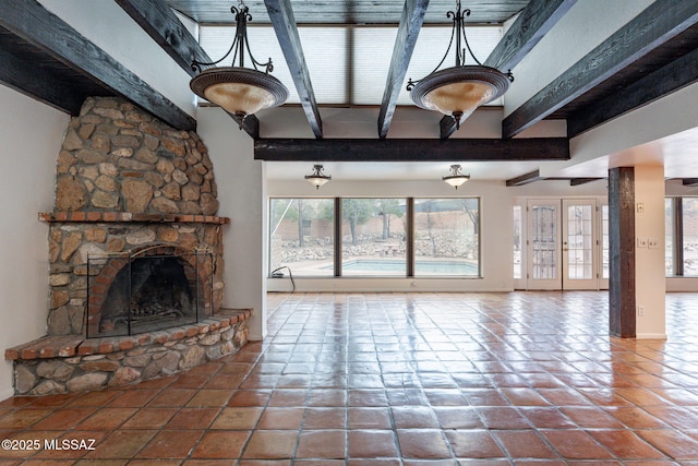 5374 E Spring Rd, Hereford, AZ 85615 - unfurnished living room with tile patterned flooring, baseboards, beamed ceiling, and a fireplace