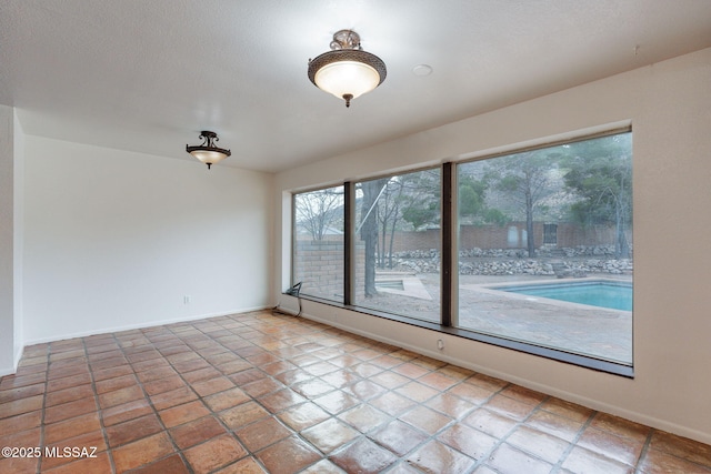 5374 E Spring Rd, Hereford, AZ 85615 - unfurnished room with baseboards and a textured ceiling