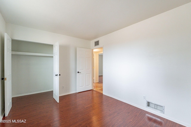 5374 E Spring Rd, Hereford, AZ 85615 - unfurnished bedroom featuring wood finished floors, a closet, baseboards, and visible vents