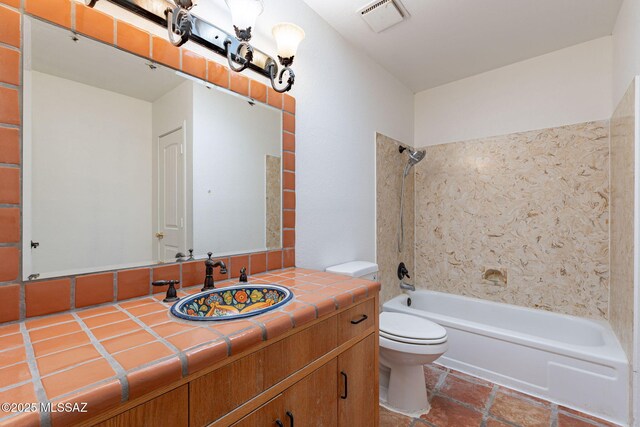 5374 E Spring Rd, Hereford, AZ 85615 - bathroom with visible vents, toilet, vanity, and washtub / shower combination