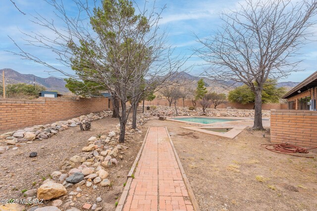 5374 E Spring Rd, Hereford, AZ 85615 - view of yard with a mountain view, a fenced in pool, and fence