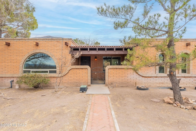 5374 E Spring Rd, Hereford, AZ 85615 - view of front of house featuring a gate, fence, and brick siding