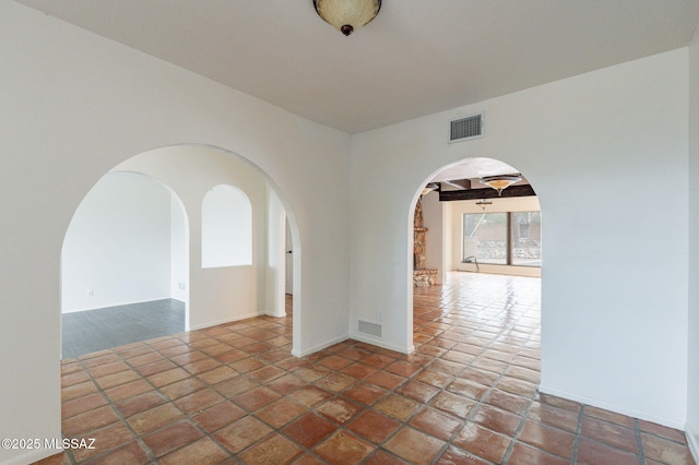 5374 E Spring Rd, Hereford, AZ 85615 - empty room with arched walkways, baseboards, and visible vents