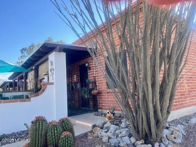 view of side of home featuring brick siding