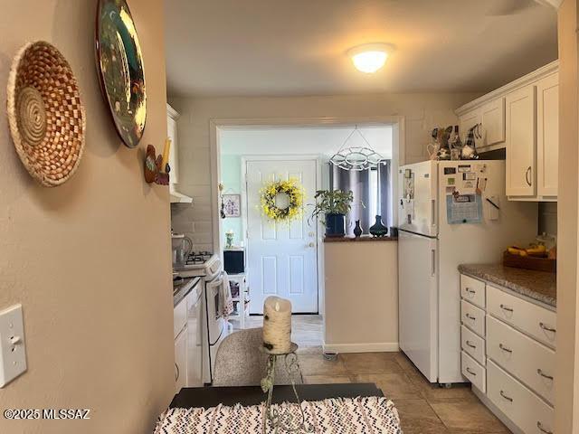 466 S Paseo Cerro Unit D, Green Valley, AZ 85614 - kitchen with white appliances, white cabinetry, and light tile patterned floors