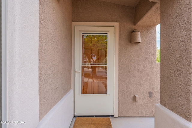 property entrance featuring stucco siding