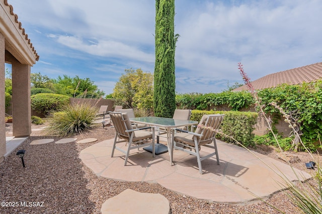 view of patio with a fenced backyard and outdoor dining area