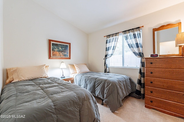bedroom with light colored carpet and vaulted ceiling