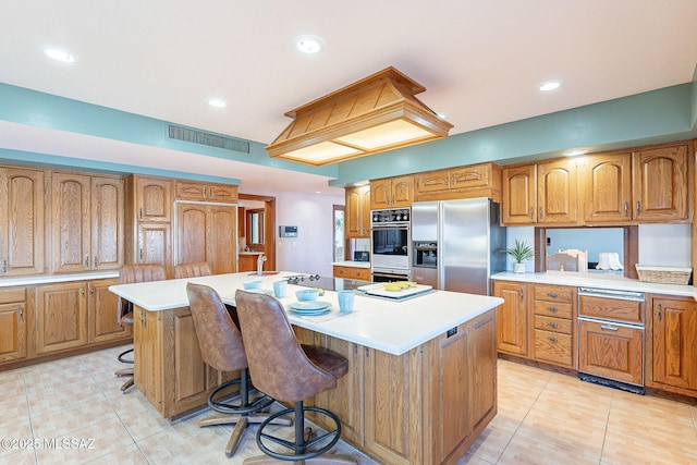 32551 S Moyza Ranch Rd, Amado, AZ 85645 - kitchen featuring light countertops, visible vents, stainless steel fridge, and brown cabinets
