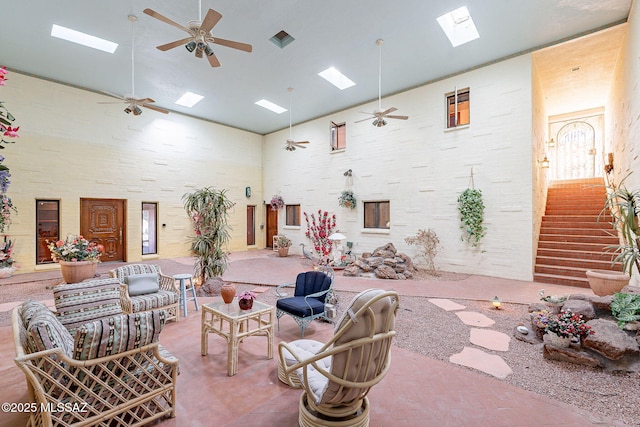 32551 S Moyza Ranch Rd, Amado, AZ 85645 - interior space featuring a towering ceiling, a skylight, stairway, and ceiling fan