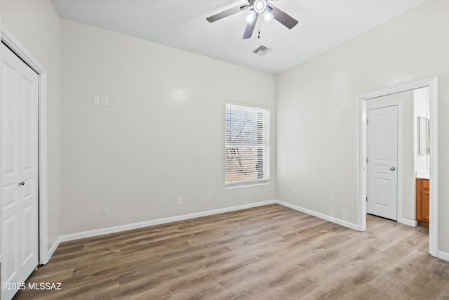 unfurnished bedroom featuring baseboards, visible vents, and light wood finished floors