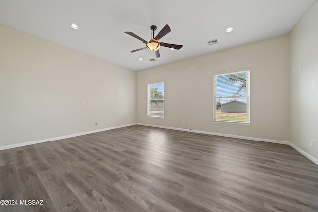 spare room featuring a ceiling fan, wood finished floors, baseboards, visible vents, and recessed lighting