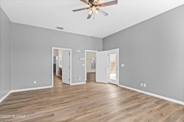 unfurnished bedroom with baseboards, visible vents, light wood-style flooring, and ensuite bath