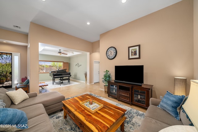 living area featuring ceiling fan, baseboards, visible vents, and recessed lighting