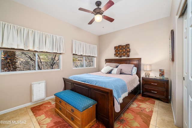 bedroom with light tile patterned floors, baseboards, and a ceiling fan