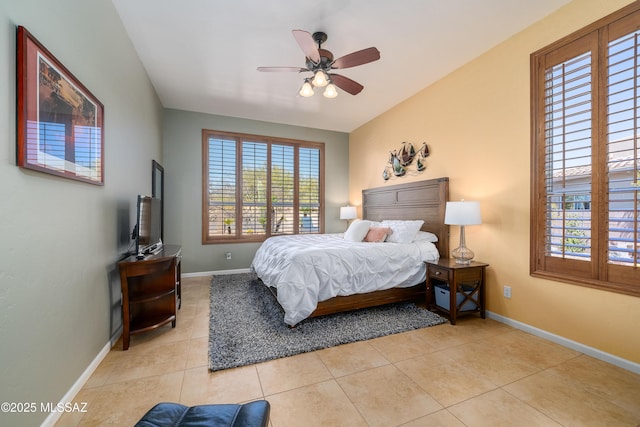 bedroom featuring light tile patterned floors, baseboards, and a ceiling fan