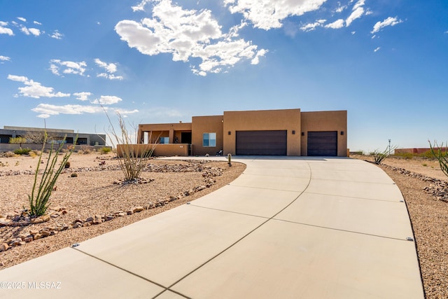 13416 S Sundown Ranch Rd, Vail, AZ 85641 - pueblo-style home featuring concrete driveway, stucco siding, and a garage