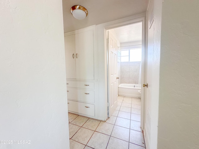 3926 E Camino De Palmas, Tucson, AZ 85711 - hallway featuring light tile patterned floors and a textured wall