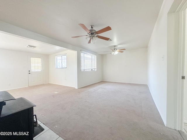3926 E Camino De Palmas, Tucson, AZ 85711 - unfurnished living room featuring light carpet, ceiling fan, and baseboards