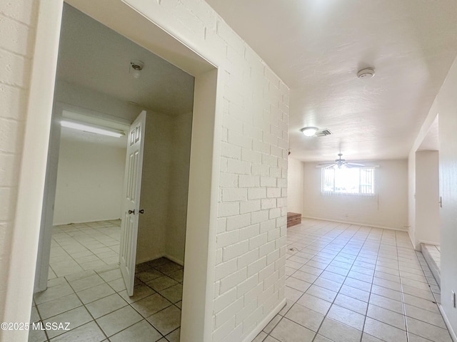 3926 E Camino De Palmas, Tucson, AZ 85711 - empty room featuring light tile patterned floors, a ceiling fan, and a smoke detector