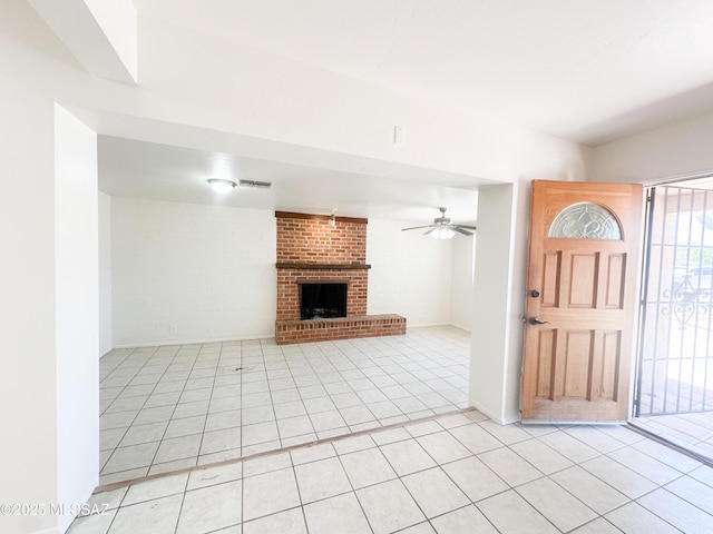 3926 E Camino De Palmas, Tucson, AZ 85711 - entrance foyer featuring light tile patterned flooring, a brick fireplace, and a ceiling fan