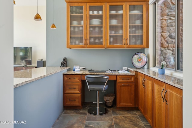 office area with stone finish floor and built in study area