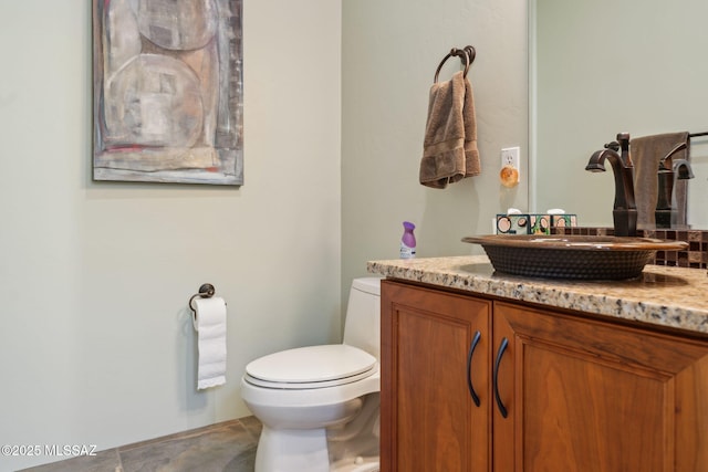 half bathroom featuring toilet and vanity