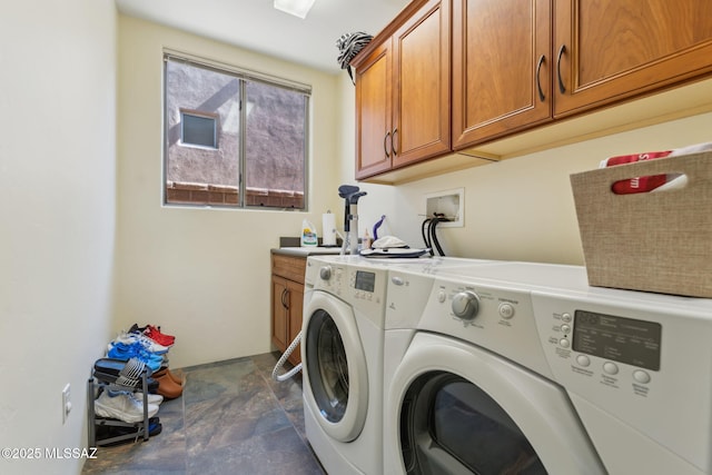 laundry room with a sink, cabinet space, and independent washer and dryer