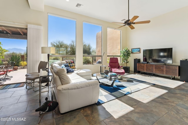 living room featuring visible vents and ceiling fan