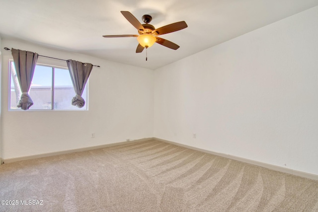 empty room with baseboards, carpet floors, and ceiling fan