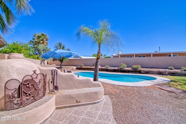 view of swimming pool with a patio area, a fenced backyard, and a fenced in pool