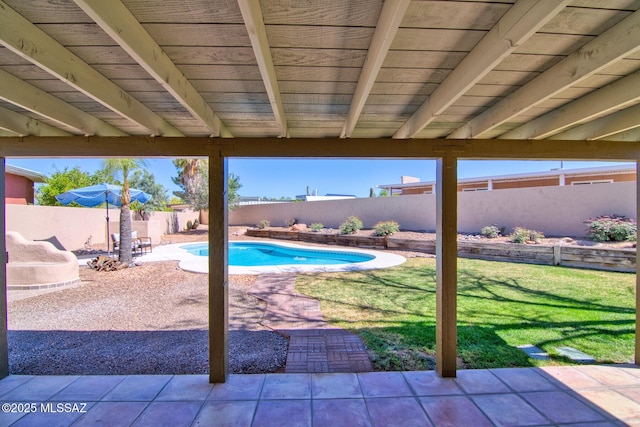 view of swimming pool featuring a yard, a patio area, a fenced in pool, and a fenced backyard