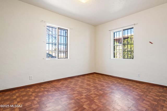 empty room featuring baseboards