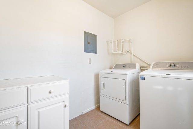 laundry room with electric panel, washer and dryer, cabinet space, and light tile patterned floors