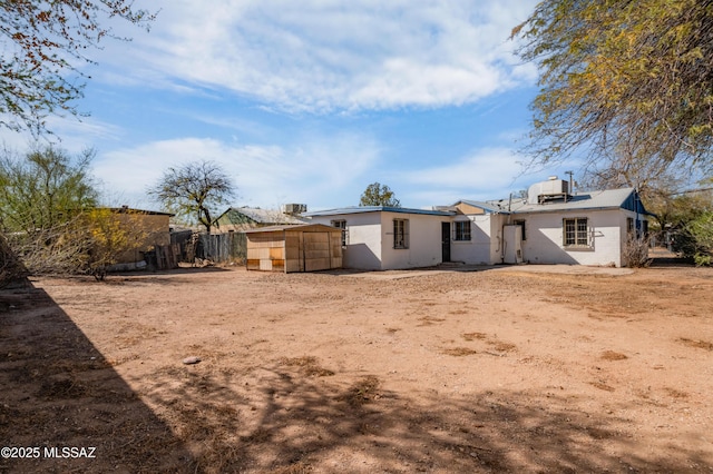 back of house featuring fence