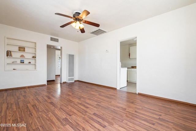 unfurnished room with baseboards, ceiling fan, visible vents, and wood finished floors