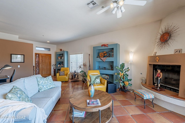 3437 S Abrego Dr, Green Valley, AZ 85614 - living area featuring visible vents, ceiling fan, and a fireplace