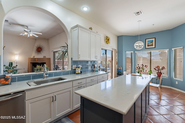 3437 S Abrego Dr, Green Valley, AZ 85614 - kitchen featuring light countertops, dishwasher, ceiling fan, a sink, and backsplash