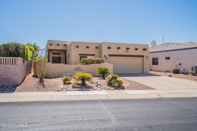 3437 S Abrego Dr, Green Valley, AZ 85614 - adobe home with a fenced front yard, a garage, stucco siding, and concrete driveway