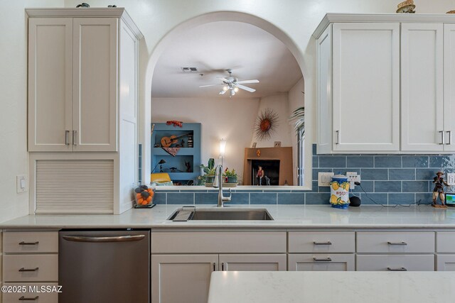 3437 S Abrego Dr, Green Valley, AZ 85614 - kitchen featuring stainless steel dishwasher, arched walkways, a sink, and a ceiling fan